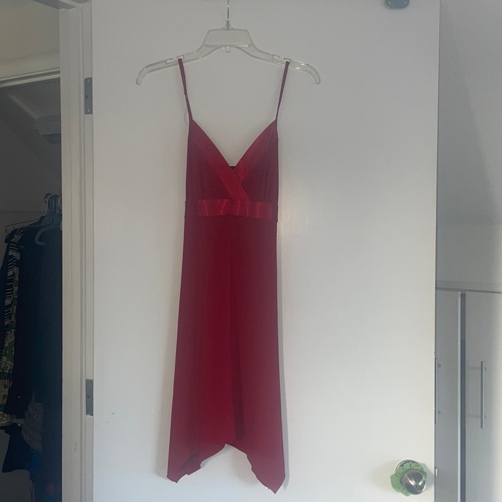 Sexy red flowing dress with spaghetti straps and asymmetrical hem.